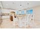 Well-appointed kitchen featuring an island with seating, custom cabinetry, granite countertops, and bright natural light at 33 Ocean Shore Blvd, Ormond Beach, FL 32176
