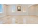 Living room featuring large windows, tile floors, and a decorative mirror, creating a bright and inviting space at 33 Ocean Shore Blvd, Ormond Beach, FL 32176