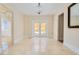 Neutral living room with white trim and travertine tile floors at 33 Ocean Shore Blvd, Ormond Beach, FL 32176