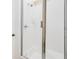 Shower featuring white tiled walls and a glass door, offering a clean and modern design at 33 Ocean Shore Blvd, Ormond Beach, FL 32176