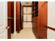 Large walk-in closet featuring extensive wood shelving, drawers, and convenient storage solutions at 33 Ocean Shore Blvd, Ormond Beach, FL 32176
