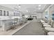 Modern bar with granite countertops, ample seating, and a view of an adjacent lounge area at 3311 S Atlantic Ave # 1704, Daytona Beach Shores, FL 32118