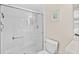 Modern bathroom features a tiled walk-in shower with glass doors, a white toilet, and neutral wall decor at 3311 S Atlantic Ave # 1704, Daytona Beach Shores, FL 32118