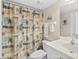 Functional bathroom featuring a patterned shower curtain, toilet, and vanity, offering essential amenities at 3311 S Atlantic Ave # 1704, Daytona Beach Shores, FL 32118
