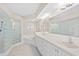 Elegant bathroom with a glass block shower and a jacuzzi tub, providing a luxurious spa-like experience at 3311 S Atlantic Ave # 1704, Daytona Beach Shores, FL 32118