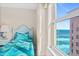 Bright bedroom with stunning ocean view, complemented by coastal decor and serene ambiance at 3311 S Atlantic Ave # 1704, Daytona Beach Shores, FL 32118