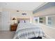 Serene bedroom with a striped bed, a bedside table, and a window offering a view of the surroundings at 3311 S Atlantic Ave # 1704, Daytona Beach Shores, FL 32118
