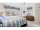Comfortable bedroom with water view, showcasing a bed with striped bedding and a cozy workspace at 3311 S Atlantic Ave # 1704, Daytona Beach Shores, FL 32118