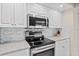 Modern kitchen appliances, including an LG microwave and stainless steel oven, complemented by white cabinetry and countertops at 3311 S Atlantic Ave # 1704, Daytona Beach Shores, FL 32118