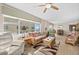 Open-concept living area showcasing tropical-style furnishings and expansive windows with breathtaking ocean views at 3311 S Atlantic Ave # 1704, Daytona Beach Shores, FL 32118