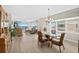 Open-concept living space seamlessly connecting the dining and living areas, highlighted by floor-to-ceiling windows at 3311 S Atlantic Ave # 1704, Daytona Beach Shores, FL 32118