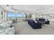 Open lounge area with a blend of seating options and panoramic ocean views through large windows at 3311 S Atlantic Ave # 1704, Daytona Beach Shores, FL 32118