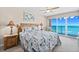 Comfortable main bedroom featuring ocean views, a wooden bed frame, and tasteful nautical decor at 3311 S Atlantic Ave # 1704, Daytona Beach Shores, FL 32118