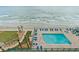 Outdoor pool area features a swimming pool, lounge chairs, and beach access for a relaxing vacation at 3311 S Atlantic Ave # 1704, Daytona Beach Shores, FL 32118