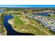 An aerial view of a golf course and residential area, with water features and mature trees at 3451 Luna Bella Ln, New Smyrna Beach, FL 32168