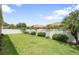 Well-maintained backyard with lush grass, neatly trimmed hedges, and a privacy fence for outdoor enjoyment at 3451 Luna Bella Ln, New Smyrna Beach, FL 32168
