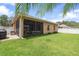 Spacious backyard featuring a screened lanai, lush grass, privacy fence, and mature landscaping at 3451 Luna Bella Ln, New Smyrna Beach, FL 32168
