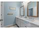 Bathroom with double sink vanity and two mirrors over the sinks at 3451 Luna Bella Ln, New Smyrna Beach, FL 32168