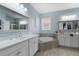 Bright bathroom featuring a large soaking tub, double sink vanity, and plenty of countertop space at 3451 Luna Bella Ln, New Smyrna Beach, FL 32168