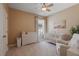 Neutral baby bedroom with crib, changing station, chair and a window at 3451 Luna Bella Ln, New Smyrna Beach, FL 32168