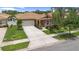 Well-manicured lawn and shrubbery add to the curb appeal of this charming single Gathering home at 3451 Luna Bella Ln, New Smyrna Beach, FL 32168