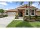 Charming single-story home showcasing lush landscaping, a tiled roof and attached two-car garage at 3451 Luna Bella Ln, New Smyrna Beach, FL 32168