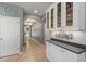 Inviting hallway featuring tile floors, neutral paint, and attractive decorative accents at 3451 Luna Bella Ln, New Smyrna Beach, FL 32168