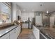 Bright kitchen with an island, stainless appliances, granite countertops and white cabinetry at 3451 Luna Bella Ln, New Smyrna Beach, FL 32168