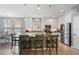 Bright kitchen with an island, stainless appliances, and a dining area at 3451 Luna Bella Ln, New Smyrna Beach, FL 32168