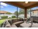 Relaxing screened lanai featuring comfortable seating and views of the well-maintained backyard at 3451 Luna Bella Ln, New Smyrna Beach, FL 32168