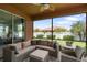 Covered lanai with comfortable seating area and ceiling fan overlooking a lush green backyard at 3451 Luna Bella Ln, New Smyrna Beach, FL 32168