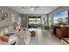 Open concept living room with a view to the outdoor living space at 3451 Luna Bella Ln, New Smyrna Beach, FL 32168