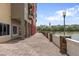Exterior view of walkway with water in background and building next to walkway at 3451 Luna Bella Ln, New Smyrna Beach, FL 32168