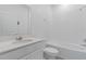 All-white bathroom featuring a tub, shower, quartz countertop vanity, and modern fixtures at 34568 Shellback St, Leesburg, FL 34788