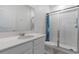 Bathroom with a glass door shower, a large mirror, and a quartz countertop vanity at 34568 Shellback St, Leesburg, FL 34788