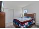 Bedroom featuring carpeted floors, a queen bed, and double-door closet at 34568 Shellback St, Leesburg, FL 34788