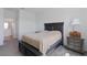 Bedroom with window, carpet and a dark wood-trimmed bed with side tables at 34568 Shellback St, Leesburg, FL 34788