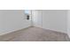 An empty bedroom has carpeted floors, a window, and a double-door closet at 34568 Shellback St, Leesburg, FL 34788