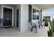 Inviting front porch with two chairs, a large window, and stylish black front door at 34568 Shellback St, Leesburg, FL 34788