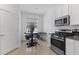 Eat-in kitchen features stainless steel appliances, bar seating, and access to laundry at 34568 Shellback St, Leesburg, FL 34788