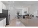 Bright kitchen featuring stainless steel appliances, a corner dining set, and tile floors at 34568 Shellback St, Leesburg, FL 34788