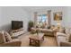 Cozy living room boasts a comfortable seating arrangement, TV, and natural light at 34568 Shellback St, Leesburg, FL 34788