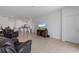 Open living room with tile flooring, comfortable seating, and bar access to the kitchen at 34568 Shellback St, Leesburg, FL 34788