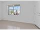 Bright, airy living room featuring neutral tile flooring and a large window at 34568 Shellback St, Leesburg, FL 34788
