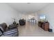Spacious living room with tile flooring, comfortable seating, and open layout at 34568 Shellback St, Leesburg, FL 34788