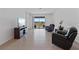 Comfortable living room featuring tile flooring, sliding glass doors and comfortable furniture at 34568 Shellback St, Leesburg, FL 34788