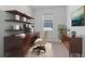 Home office features built-in shelving, a comfortable workspace, and natural light at 34568 Shellback St, Leesburg, FL 34788