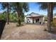 Spacious backyard with a covered patio, black fence and mature trees at 357 Heritage Estates Ln, Deland, FL 32720
