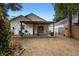Large backyard featuring a covered patio, bench seating, and secure black fencing at 357 Heritage Estates Ln, Deland, FL 32720
