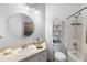 Bright bathroom with a large mirror, storage shelves, and a shower-tub combination at 357 Heritage Estates Ln, Deland, FL 32720